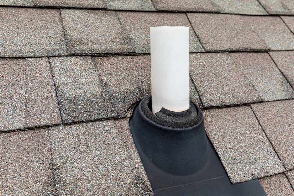 A person using binoculars to inspect a house roof from the ground after a heavy storm.